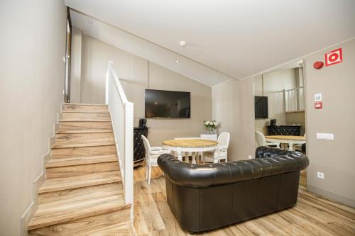 a living room with a couch and a table at Les Clarisses Boutique Hotel in Vic