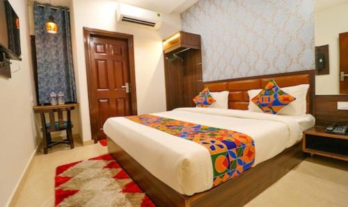a bedroom with a large bed in a room at Hotel California Heights in Amritsar