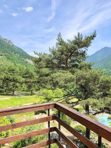 a wooden balcony with a view of a mountain at Mas du Gralet, entre terre et mer in Puget-Théniers