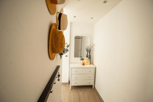 a hallway with a dresser and a mirror at Marinca Port View Toulon in Toulon