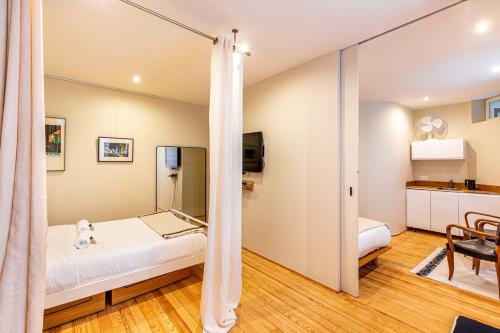 Cette chambre comprend un lit et un miroir. dans l'établissement GuestReady -Beautiful 2-Room in the Heart of Paris, à Paris