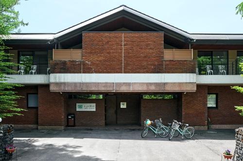 two bikes parked in front of a brick building at IKOI Villa in Karuizawa