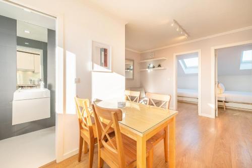 a kitchen and dining room with a table and chairs at GuestReady - Sunny spacious in Belém in Lisbon