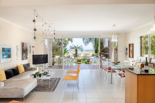 a living room with a couch and a table at Chelidonia Larnaca Seafront Villa in Meneou