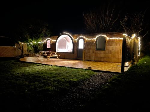 a yurt lit up at night with lights at Dreckly cabin - Lydcott Glamping with Cornish sea views in Looe