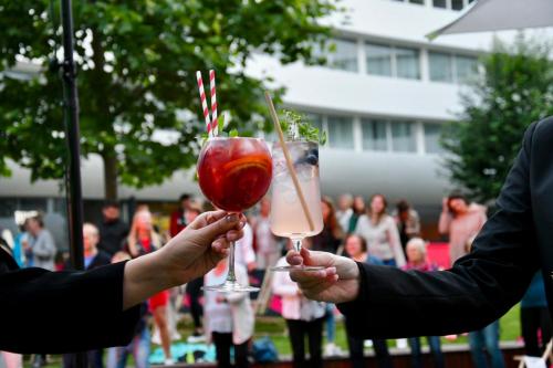 two people holding up glasses with drinks in their hands at DoubleTree by Hilton Wroclaw in Wrocław