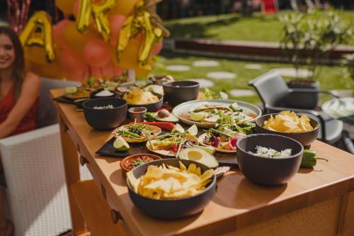 a table filled with plates of food and bowls of food at DoubleTree by Hilton Wroclaw in Wrocław