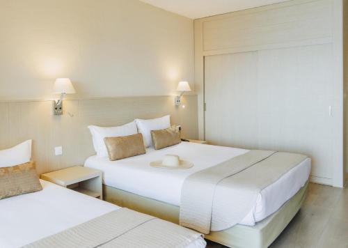 a hotel room with two beds and a window at Alivi in Bastia