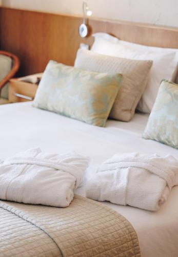 two white pillows sitting on top of a bed at Alivi in Bastia