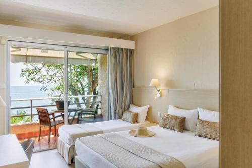 a hotel room with two beds and a balcony at Alivi in Bastia