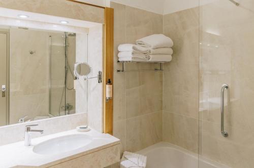 a bathroom with a shower and a sink and a tub at Alivi in Bastia