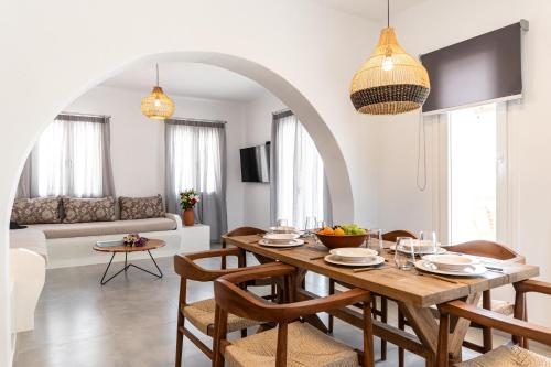 a dining room and living room with a table and chairs at Villa Margarita 3 Bedroom Villa with Private Pool and Sea View in Naxos Chora