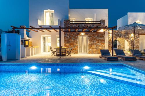 a swimming pool in front of a villa at Villa Margarita 3 Bedroom Villa with Private Pool and Sea View in Naxos Chora