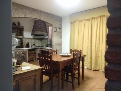 a kitchen with a wooden table and chairs and a dining room at Villa Hephaestus Etna - with private pool in Ragalna