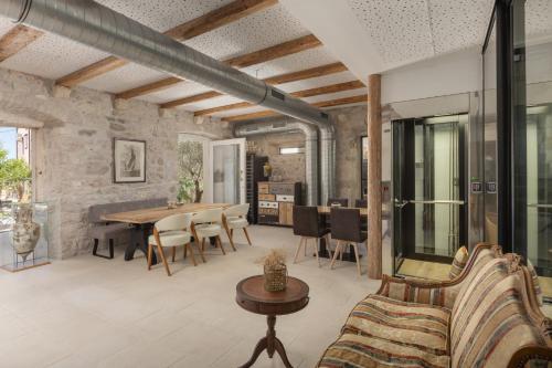 an open living room with a table and chairs at Casa Columba - 4 Star Design Boutique Hotel with Outdoor Pool & Private Garden in Makarska
