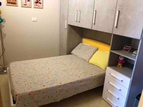 a small bedroom with a bed and a cabinet at Casa vacanze Conte in Sannicandro di Bari
