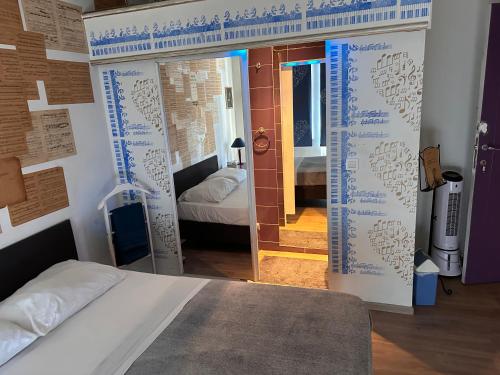 a bedroom with a bed and a door with writing on it at Chambre musicale in Brussels