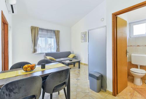 a living room with a couch and a table and chairs at Apartment house Inga in Vir