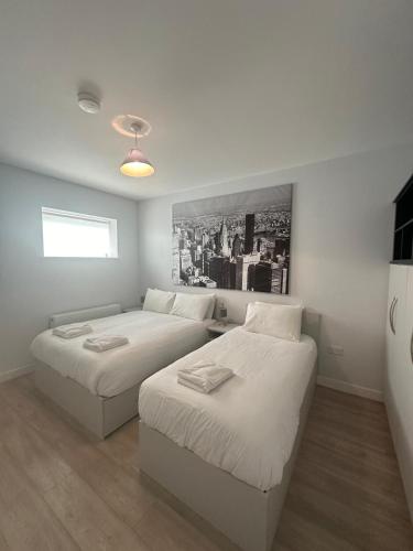 a bedroom with two beds and a couch at SWUITE GALWAY in Galway
