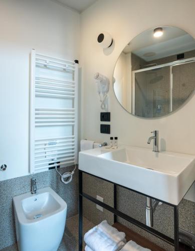 a bathroom with a sink and a mirror at Hotel Casa Del Pellegrino in Padova