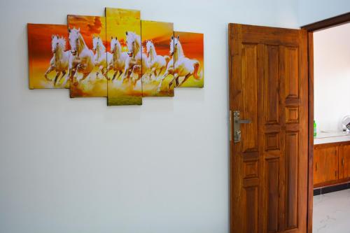 a room with a painting on the wall at Jungle View Inn in Trincomalee