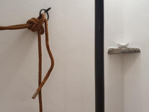 a piece of rope tied to a wall with a box at Casa Lavinia - open space con terrazza privata in Lipari