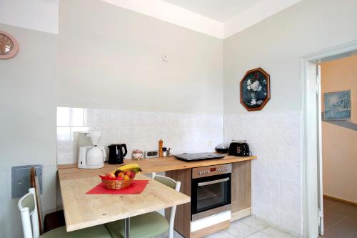 a kitchen with a table with a bowl of fruit on it at Haus Meistereck Melzow in Melzow