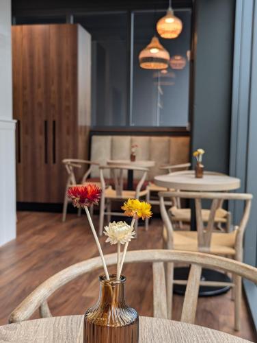 a vase with flowers in it sitting on a table at Smart Brickell Hotel in Miami
