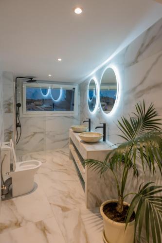 a bathroom with a toilet and a sink at Para Thin Alos Skiathos in Skiathos