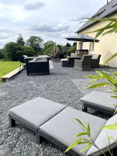 a patio with benches and a grill and a playground at Spacious Luxury countryside retreat in Estry