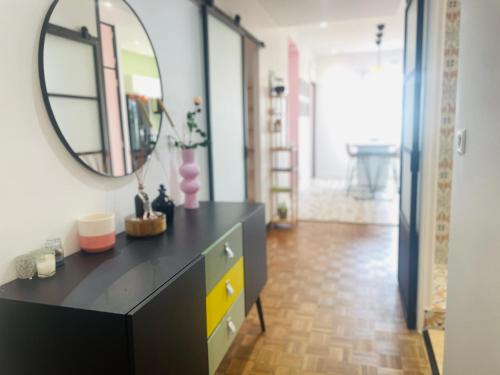 La salle de bains est pourvue d'une commode noire et d'un miroir. dans l'établissement Hysope YourHostHelper, à Caen