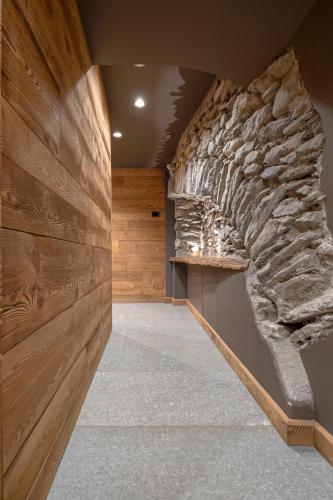 a room with a stone wall and a stairway at Grande Cote Room and Breakfast in Cesana Torinese