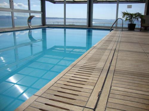 a swimming pool with a view of the ocean at Hotel Gala Split in Podstrana