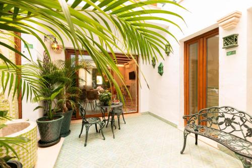 a patio with a table and chairs and plants at Casa Esmeralda - Luxury Boutique Apartments Old Town in Estepona