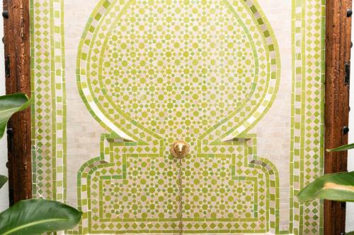 a tile wall with a door with a design on it at Casa Esmeralda - Luxury Boutique Apartments Old Town in Estepona