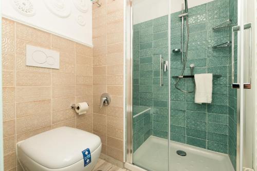 a bathroom with a toilet and a glass shower at Casa Esmeralda - Luxury Boutique Apartments Old Town in Estepona