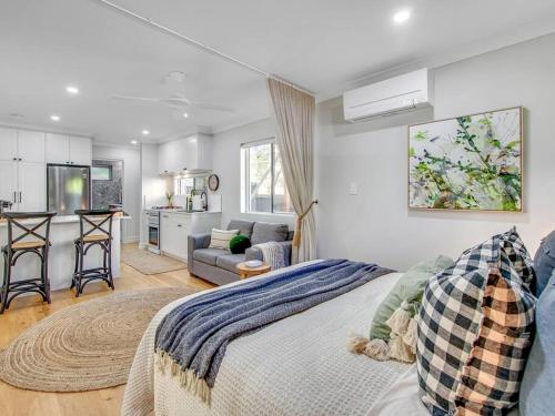 a bedroom with a bed and a living room at Comfort Cove - quiet luxury with full kitchen in Brisbane