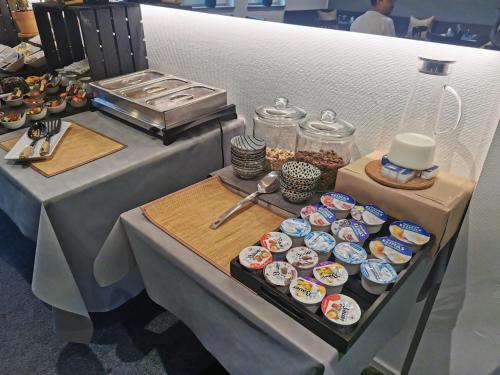 a table with cupcakes and other food on it at Akteon Hotel in Stuttgart