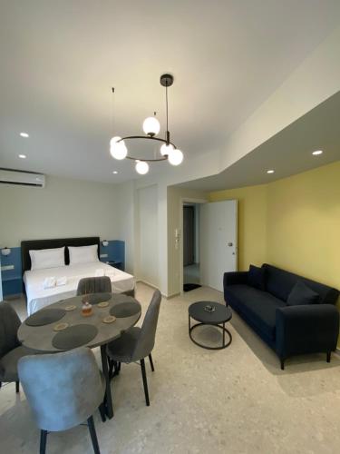 a living room with a bed and a couch and a table at 3rd Floor A MicroApartment in Kavala