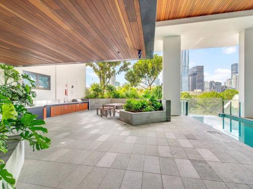 an open kitchen and living area of a house with a patio at Modern Mountain View Apartment - South Brisbane in Brisbane