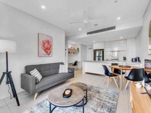 a living room with a couch and a table at Modern Mountain View Apartment - South Brisbane in Brisbane