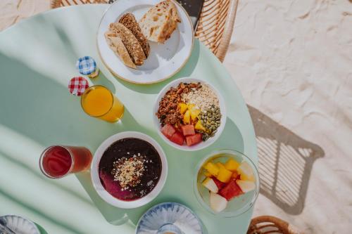 a tray with three plates of food on a table at Nativo Hotel Ibiza in Santa Eularia des Riu