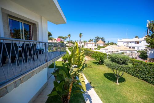 a balcony of a house with a yard at Villa Venera Fontane Bianche Charme Apartments in Fontane Bianche