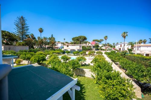 a view of a garden with a tennis court at Villa Venera Fontane Bianche Charme Apartments in Fontane Bianche