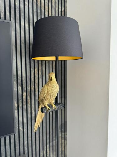 a lamp with a bird sitting on top of it at Ferienhaus Zörweg - Feels like home in Matzling