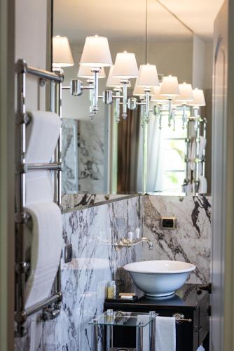 a bathroom with a sink and a mirror at Hotel Vannucci in Città della Pieve