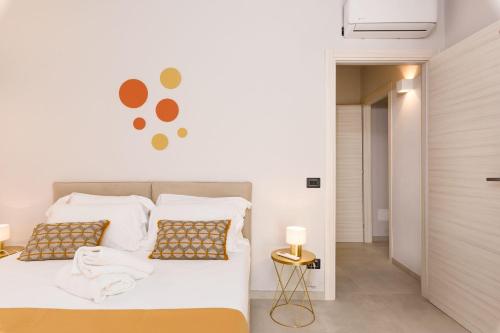 a bedroom with a bed with white sheets and pillows at La Grignola Apartments in Canale