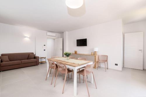 a living room with a table and chairs and a couch at La Grignola Apartments in Canale