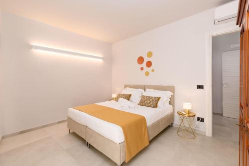 a white bedroom with a large bed in it at La Grignola Apartments in Canale