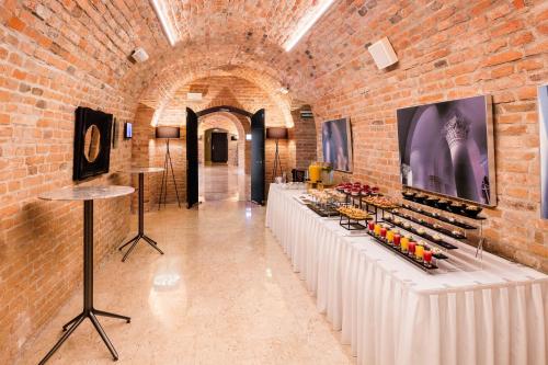 a room with rows of tables with wine bottles at Grand Palace Brno - Czech Leading Hotels in Brno